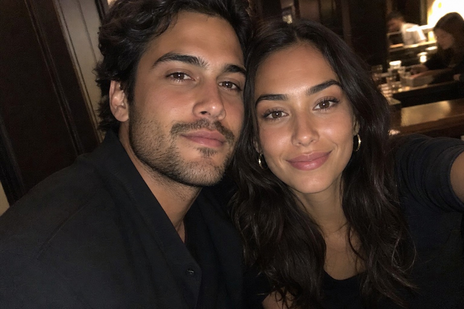 The couple at dinner in a warm-lit restaurant