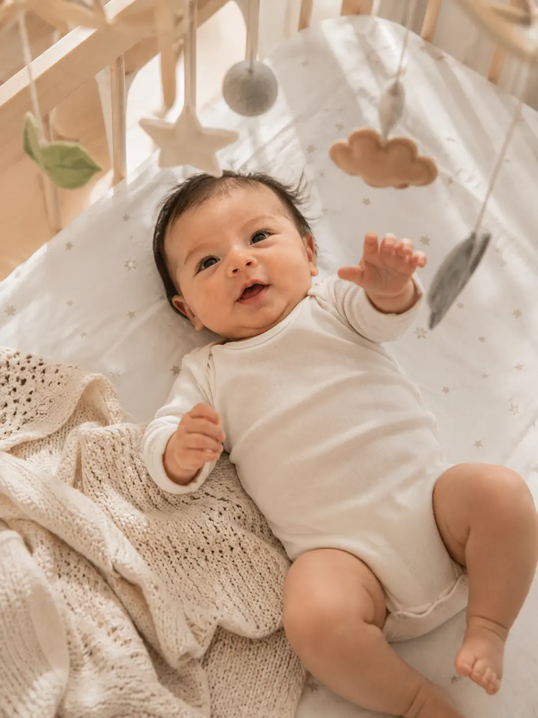 Baby in a nursery cot at six months